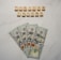 A marble surface displays five 100-dollar bills arranged in a fan shape. Above the bills, the words PASSIVE INCOME are spelled using wooden Scrabble tiles.